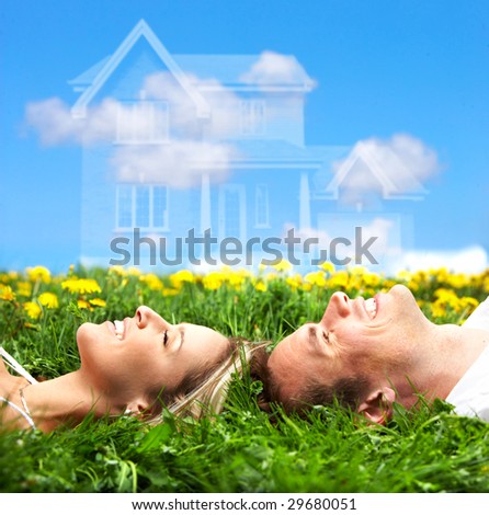 stock photo : Young love couple smiling dreaming about a new home.  Real estate concept