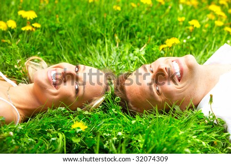 Young love couple on the green grass