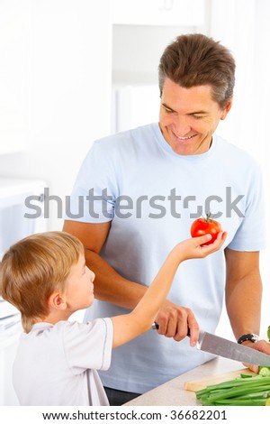 Father and his son cooking in the kitchen