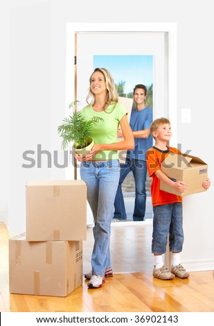Young happy family moving into their new home