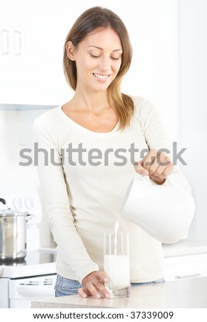 Beautiful smiling woman drinking milk