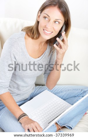 Beautiful smiling woman with cellular at home