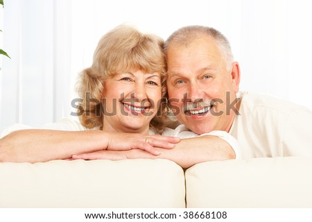 Happy smiling elderly couple at home