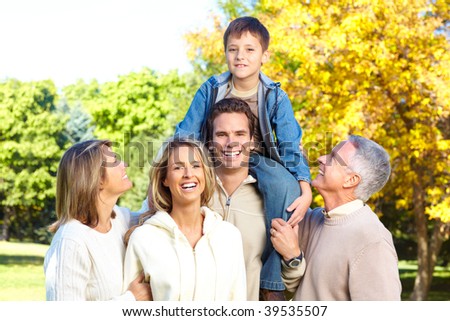 Happy family in park. Grandfather, grandmother, father, mother and son