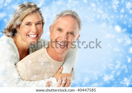 Elderly happy couple. Over snow blue background