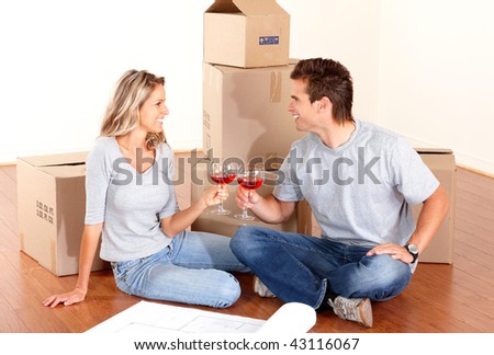Young couple sitting on the floor after moving