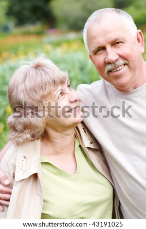 Happy elderly seniors couple in park