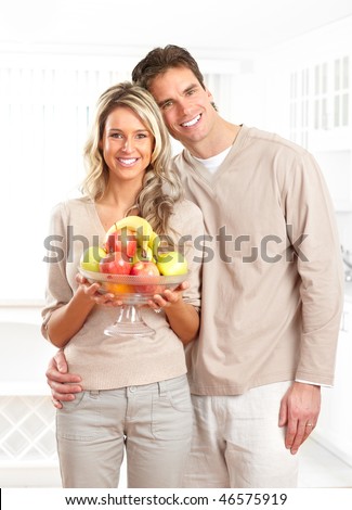 Young love couple with fruits at kitchen