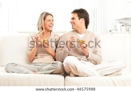 Young smiling couple having lunch at home