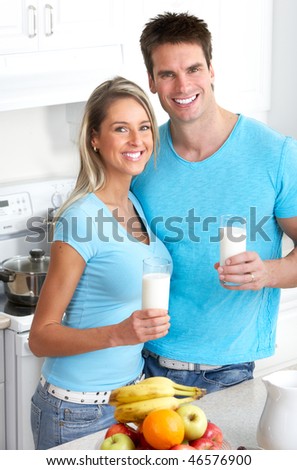 Young smiling couple having lunch at home