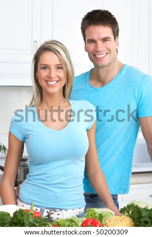 Happy smiling couple in love at kitchen