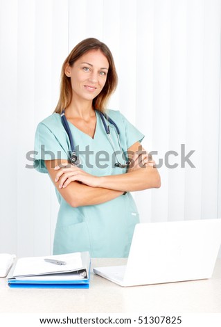 Smiling medical doctor working with laptop. Over white background