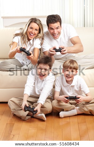 Happy family. Father, mother and children playing a video game
