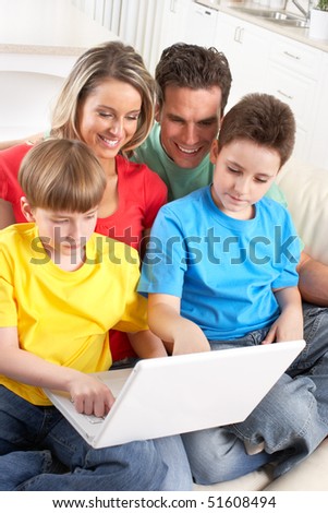 Happy family. Father, mother and boy working with laptop.
