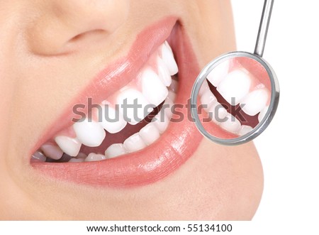 Healthy woman teeth and a dentist mouth mirror Healthy woman teeth and a dentist mouth mirror