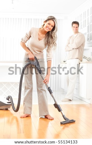 Housework, vacuum cleaner, young couple, home, kitchen. Housework