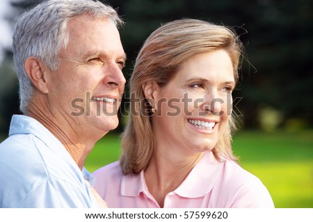 Happy elderly senior couple in park