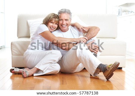 Senior couple at home smiling and happy