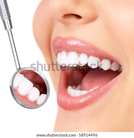 Healthy woman teeth and a dentist mouth mirror Healthy woman teeth and a dentist mouth mirror