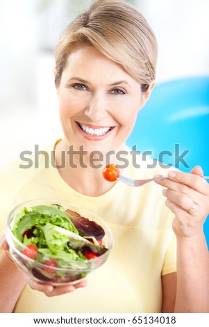 Mature smiling woman  with fruits and vegetables.