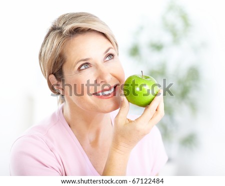 Mature smiling woman with apple