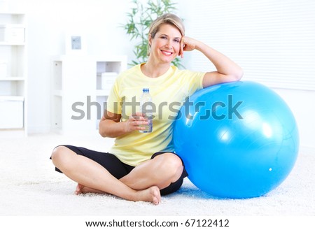Fitness woman with a bottle of spring water
