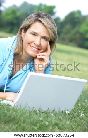 Happy smiling elderly woman working with laptop
