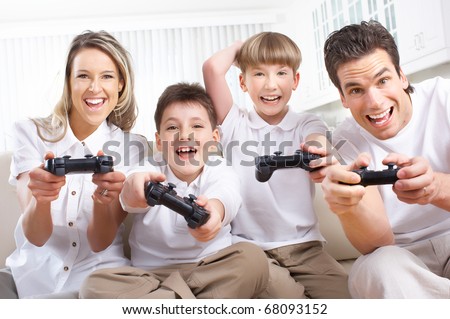 Happy family. Father, mother and children playing a video game