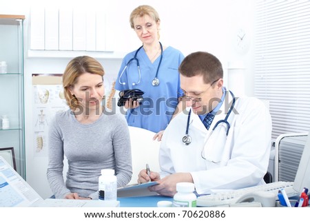 Medical doctors and a woman patient.
