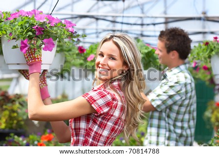 Gardening. Young smiling people florists working in the garden.
