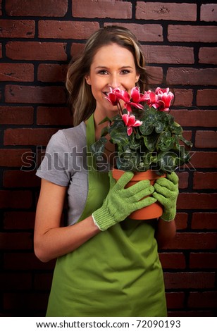 Gardening. Woman worker with flowers.