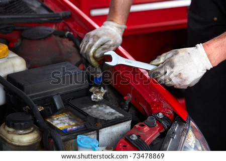 Hands with wrench. Mechanic. Auto repair shop.