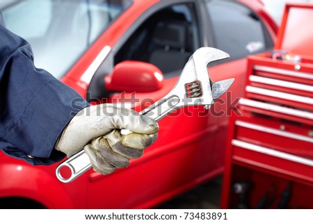 Hands with wrench. Mechanic. Auto repair shop.