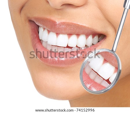 Healthy woman teeth and a dentist mouth mirror Healthy woman teeth and a dentist mouth mirror