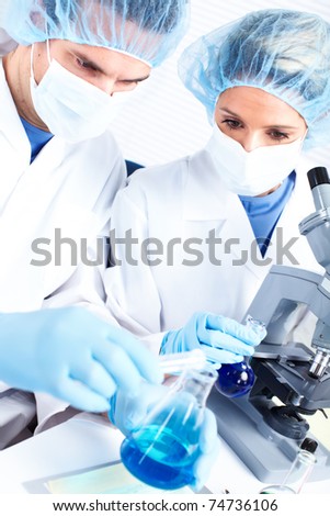Science team working with microscopes at  laboratory