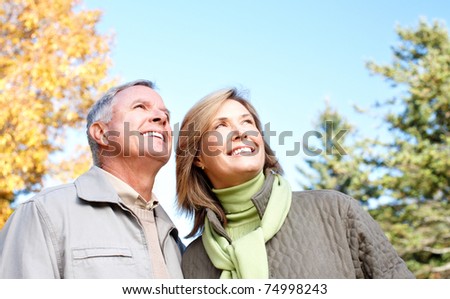 Happy elderly seniors couple in park. Love.