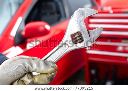 Hand with wrench. Mechanic. Auto repair shop.