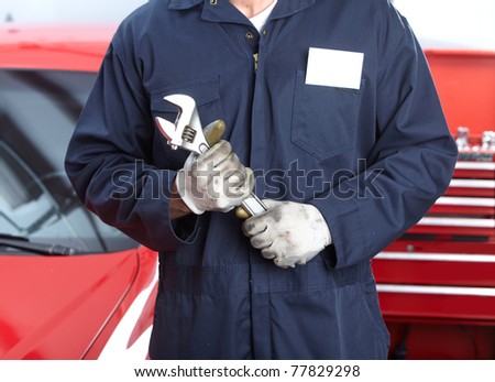 Mechanic with wrench.  Auto repair shop service.