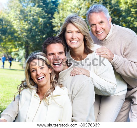 Happy family in park. Father, mother, son and daughter