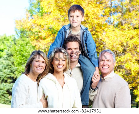 Happy family in park. Grandfather, grandmother, father, mother and son