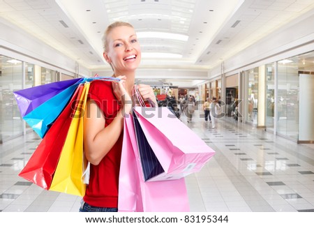 Group of smiling shopping people in modern mall.