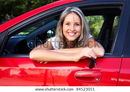 Happy smiling woman with car key. Driving.