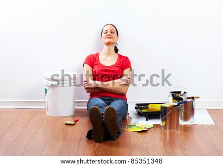 Young woman doing renovation interior wall of home.