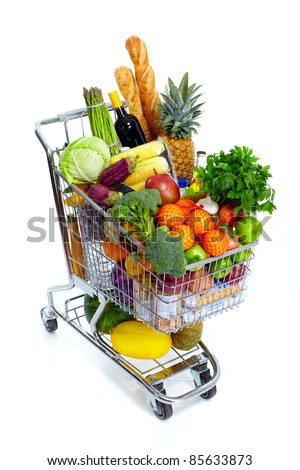 Metal shopping cart with grocery items. Isolated over white background.