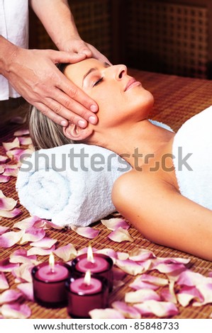 Beautiful young woman in a day spa getting massage. Relax.