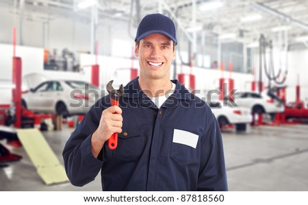 Professional auto mechanic in auto repair shop. Garage.