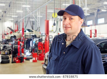 Professional auto mechanic in auto repair shop. Garage.