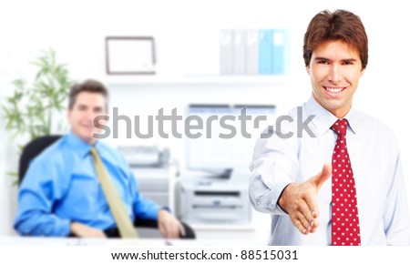 Businessman with handshake in a modern office. Business meeting. Isolated over white background.