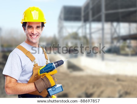 Industrial worker with yellow helmet at the construction plant.