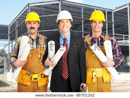 Industrial workers with yellow helmet at the construction plant.